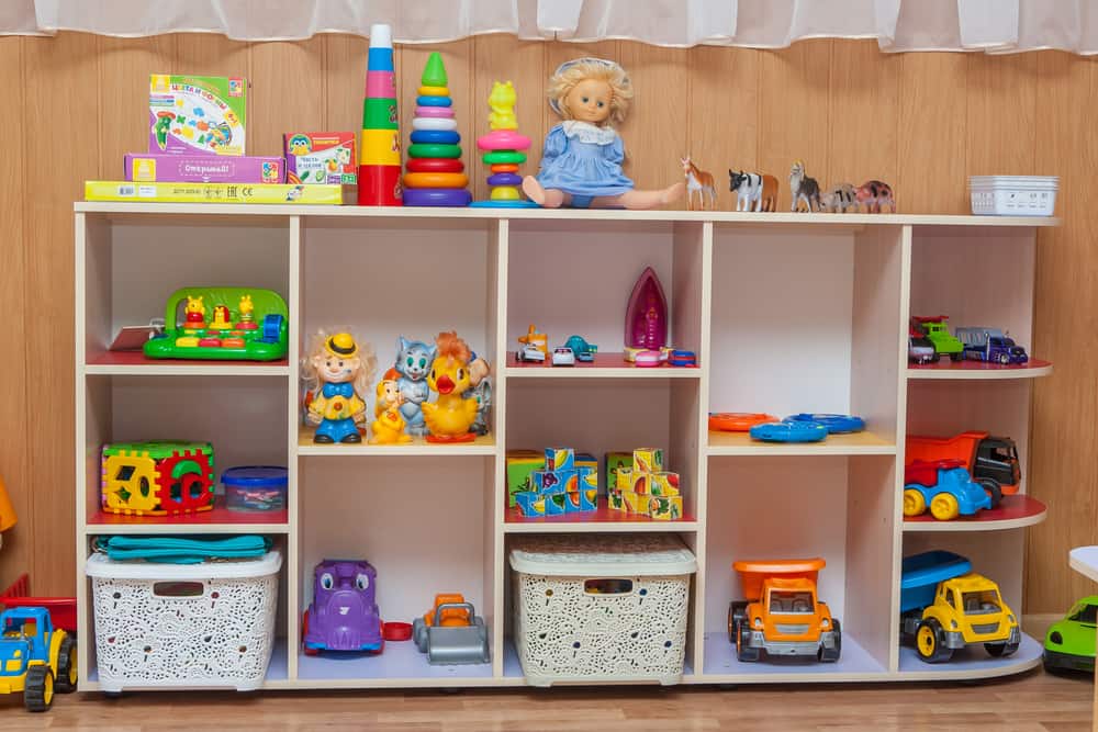 Children furniture with plastic colorful educational blocks toys. Cupboard for preschoolers kindergarten.