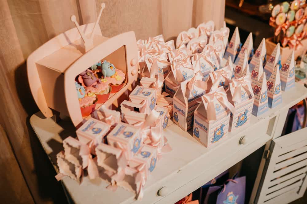 A high angle shot of colorful gift boxes with a funny chicken character