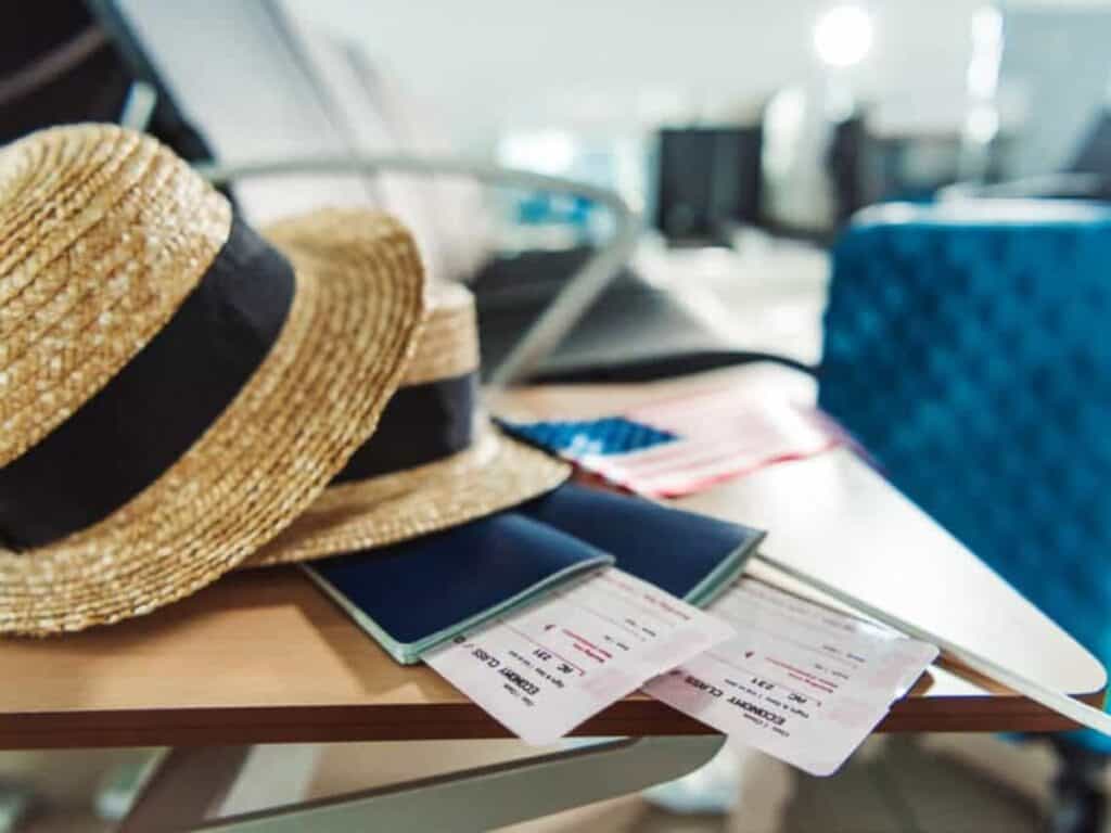 A hat and passport on a table ready for travel