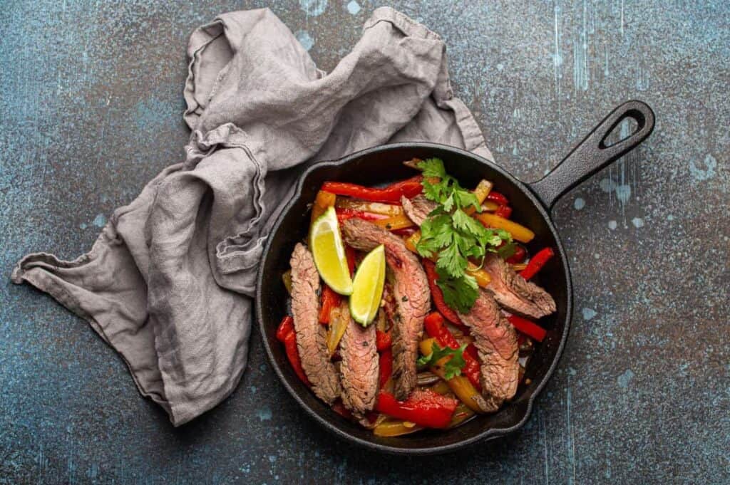 cast iron skillet with fajita ingredients