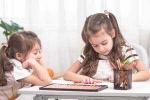 Kids playing pen and paper games.