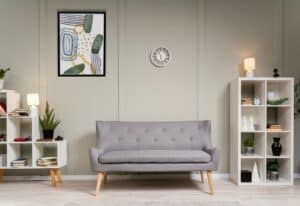 Interior design with photoframes and grey couch.